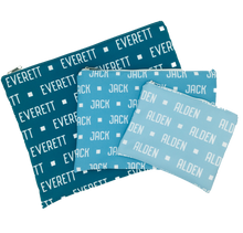 Load image into Gallery viewer, Large, medium and small custom name travel bags in different shades of blue