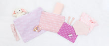 Load image into Gallery viewer, Set of pink custom name travel bags in different shades with different fonts laid flat with baby items sticking out